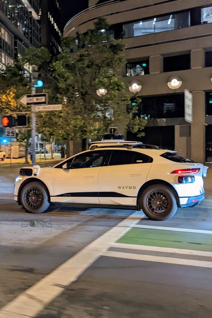 A self driving Waymo taxi running in a street of San Francisco