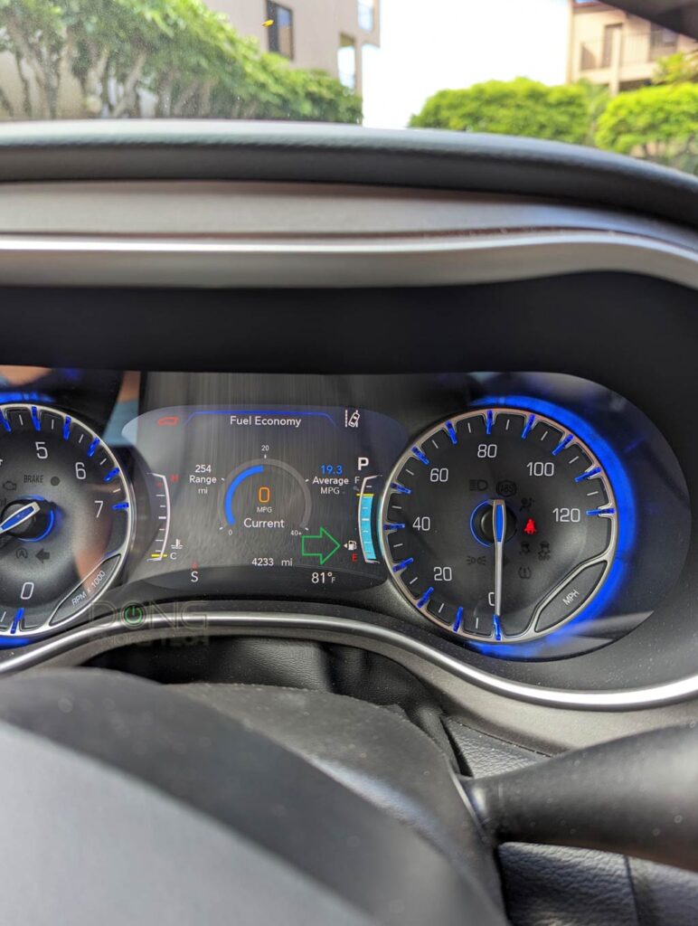 Handy traveling tip: The dashboard of the Chrysler Pacifica. Note the little arrow by the gas gauge that points to the left -- this car's gas tank cap is on the driver's side.